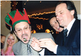 Larry feeds NMW's writer/attorney John Loggins at the 3rd annual New Music Weekly anniversary in Hollywood, CA.