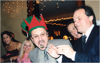 Larry feeds NMW's writer/attorney John Loggins at the 3rd annual New Music Weekly anniversary in Hollywood, CA.